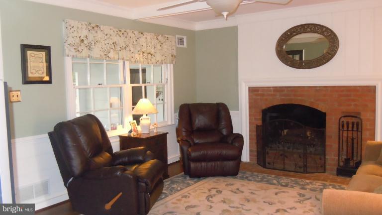 15613 Jones Lane Gaithersburg, MD 20878 - Photo 16 of 21 a living room with furniture and a fireplace