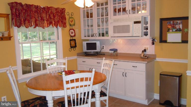 15613 Jones Lane Gaithersburg, MD 20878 - Photo 19 of 21 a table and chairs in a kitchen next to a window
