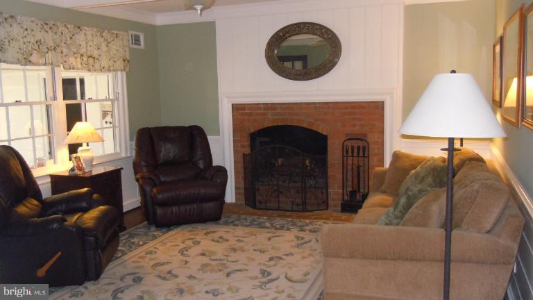 15613 Jones Lane Gaithersburg, MD 20878 - Photo 20 of 21 a living room with furniture and a fireplace