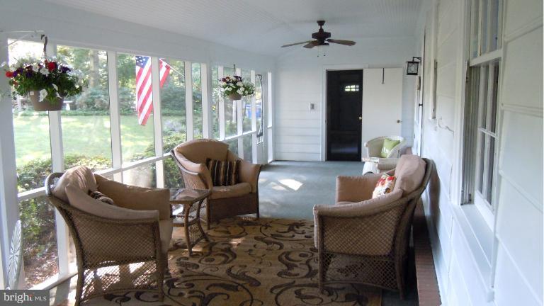 15613 Jones Lane Gaithersburg, MD 20878 - Photo 3 of 21 a living room with furniture and a floor to ceiling window