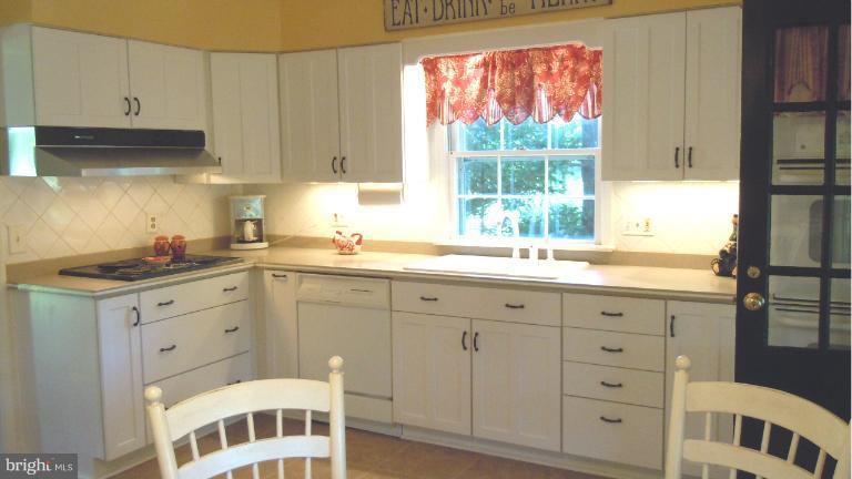 15613 Jones Lane Gaithersburg, MD 20878 - Photo 21 of 21 a kitchen with granite countertop white cabinets and a window