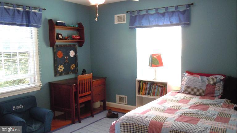 15613 Jones Lane Gaithersburg, MD 20878 - Photo 7 of 21 a bedroom with a bed and a television