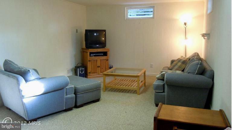 15613 Jones Lane Gaithersburg, MD 20878 - Photo 9 of 21 a living room with furniture and a flat screen tv
