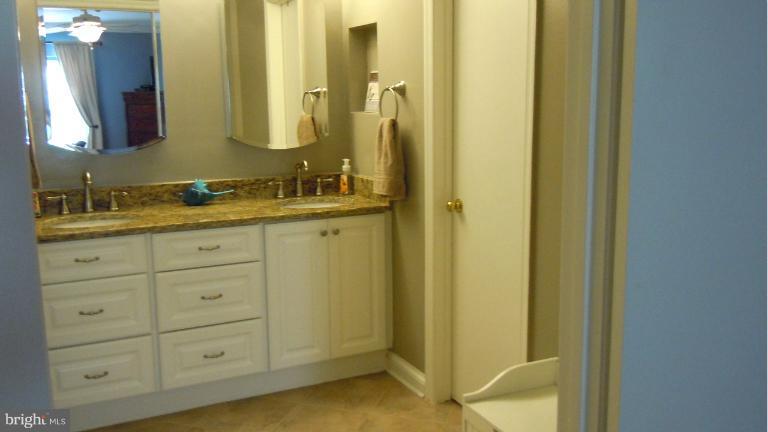 15613 Jones Lane Gaithersburg, MD 20878 - Photo 10 of 21 a bathroom with a granite countertop sink and a mirror