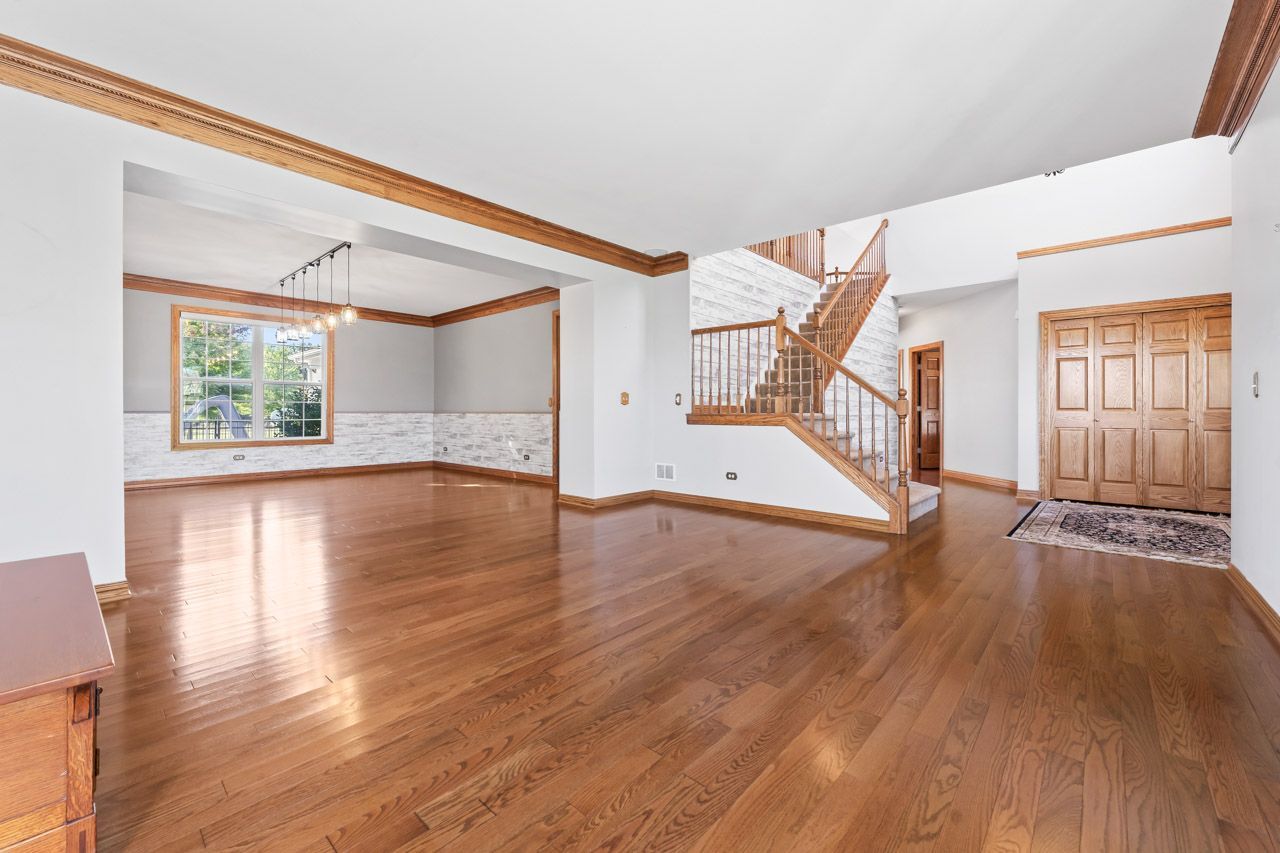 9307 Daniel Lane Spring Grove, IL 60081 - Photo 12 of 70 a view of an empty room with wooden floor and a window