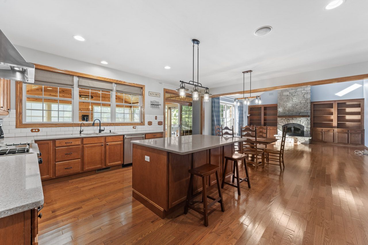 9307 Daniel Lane Spring Grove, IL 60081 - Photo 17 of 70 a kitchen with stainless steel appliances granite countertop wooden floors and white cabinets