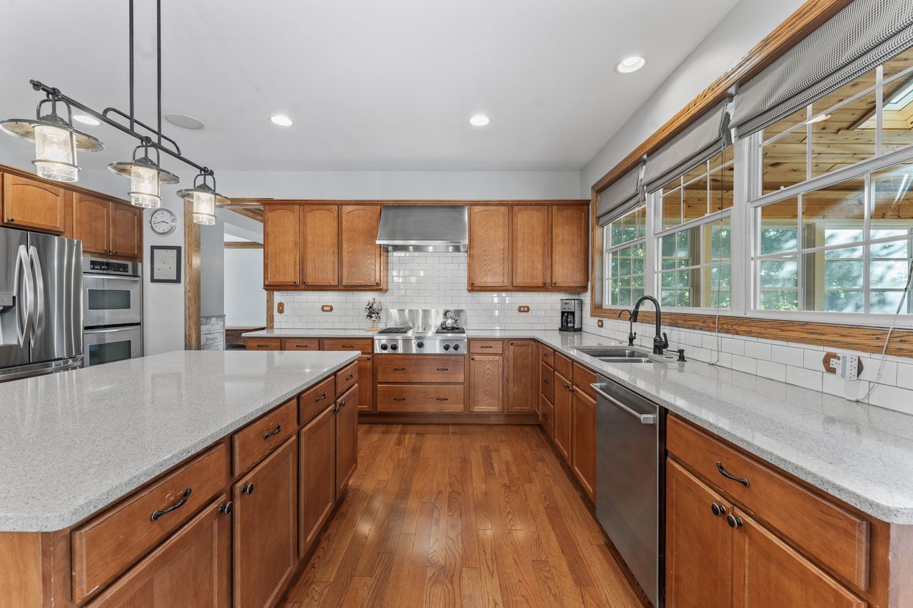 9307 Daniel Lane Spring Grove, IL 60081 - Photo 20 of 70 a large kitchen with stainless steel appliances granite countertop a sink and counter space