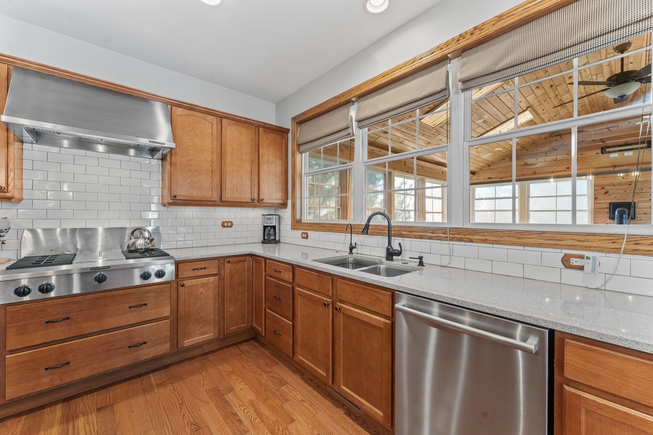 9307 Daniel Lane Spring Grove, IL 60081 - Photo 22 of 70 a kitchen with a sink stove and cabinets