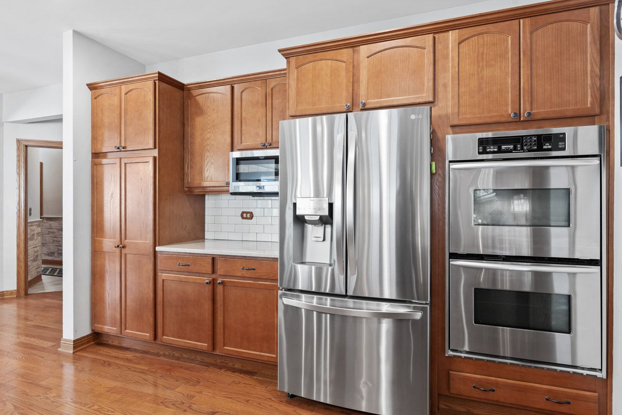 9307 Daniel Lane Spring Grove, IL 60081 - Photo 24 of 70 a kitchen with stainless steel appliances granite countertop a refrigerator microwave and cabinets