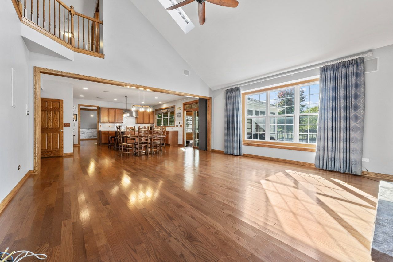 9307 Daniel Lane Spring Grove, IL 60081 - Photo 30 of 70 a view of dining room with furniture window and wooden floor