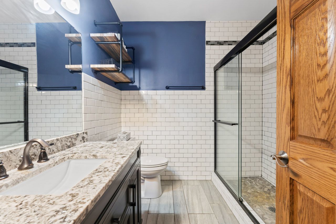 9307 Daniel Lane Spring Grove, IL 60081 - Photo 37 of 70 a bathroom with a granite countertop sink toilet and shower