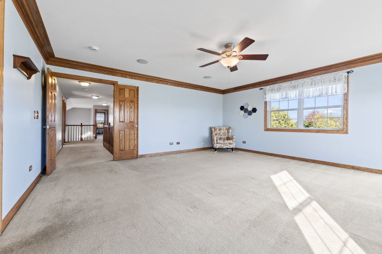 9307 Daniel Lane Spring Grove, IL 60081 - Photo 41 of 70 a view of a livingroom with a ceiling fan and window