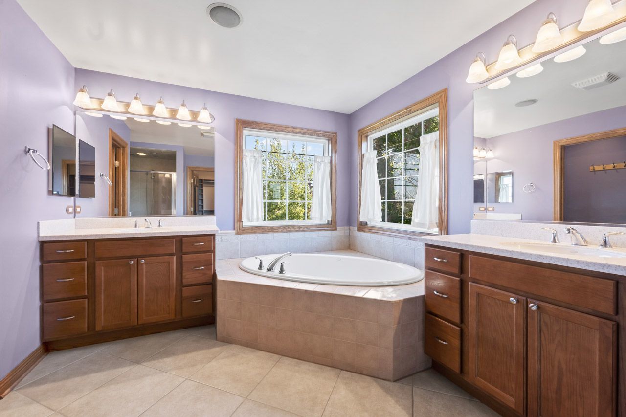 9307 Daniel Lane Spring Grove, IL 60081 - Photo 42 of 70 a spacious bathroom with a tub sink and mirror