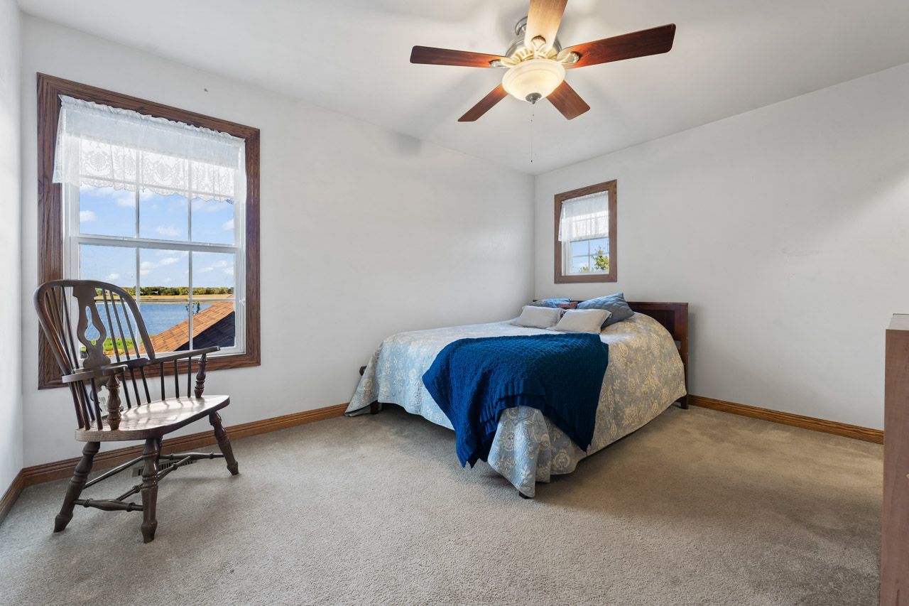 9307 Daniel Lane Spring Grove, IL 60081 - Photo 47 of 70 a bedroom with a bed chair and two windows