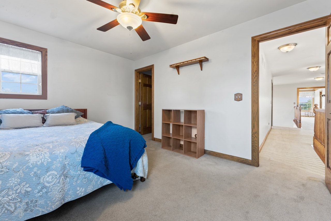 9307 Daniel Lane Spring Grove, IL 60081 - Photo 48 of 70 a bedroom with a bed and a chandelier