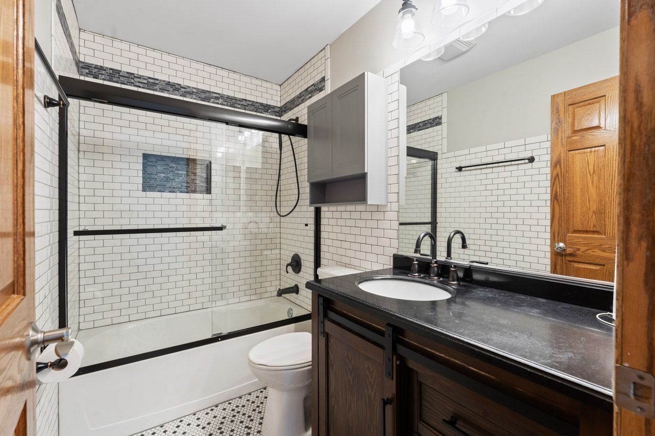 9307 Daniel Lane Spring Grove, IL 60081 - Photo 50 of 70 a bathroom with a sink a toilet and shower