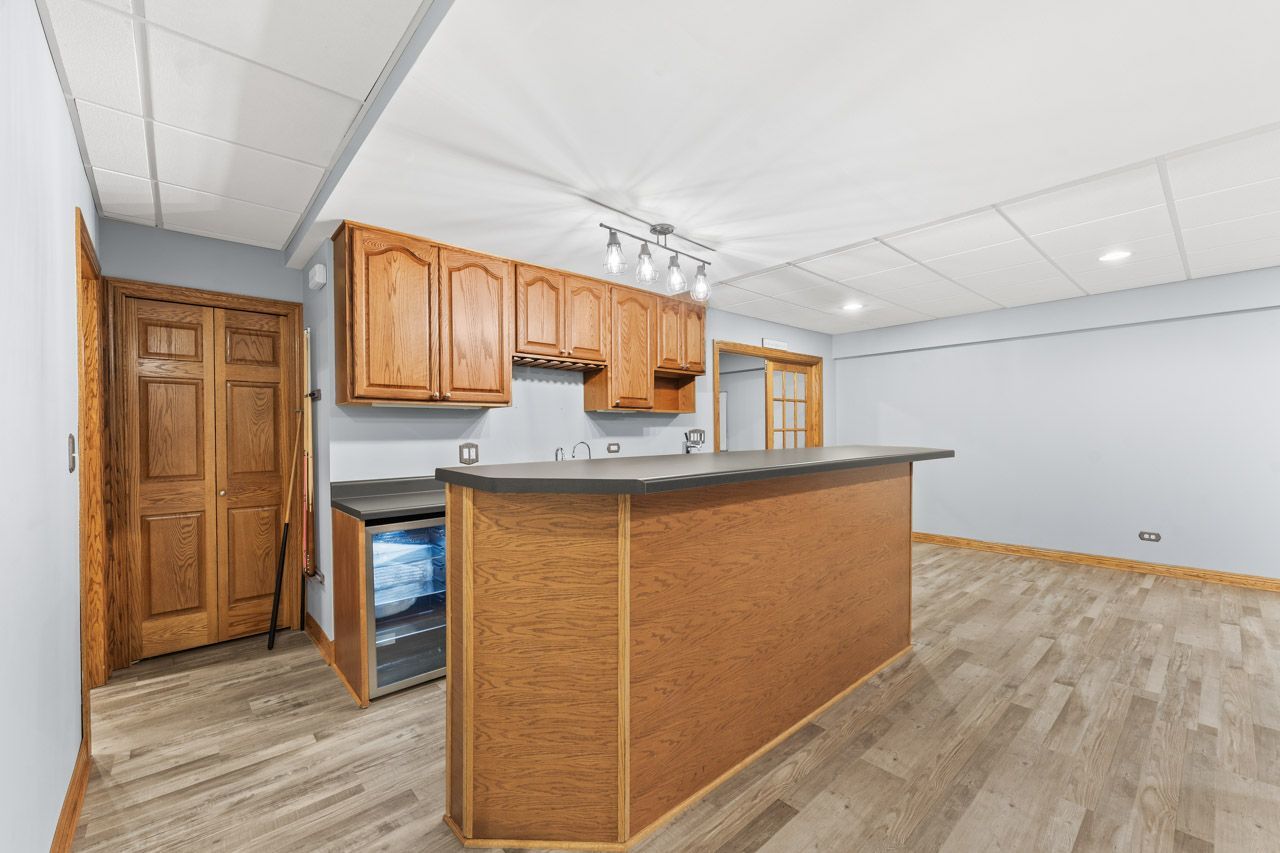 9307 Daniel Lane Spring Grove, IL 60081 - Photo 56 of 70 a view of kitchen with granite countertop cabinets and wooden floor