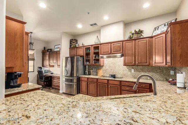 a bathroom with a granite countertop sink mirror vanity and toilet