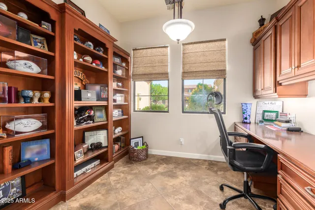 a view of hallway with granite countertop lots of wooden cabinets a sink
