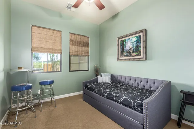 a view of a balcony with couches and wooden fence