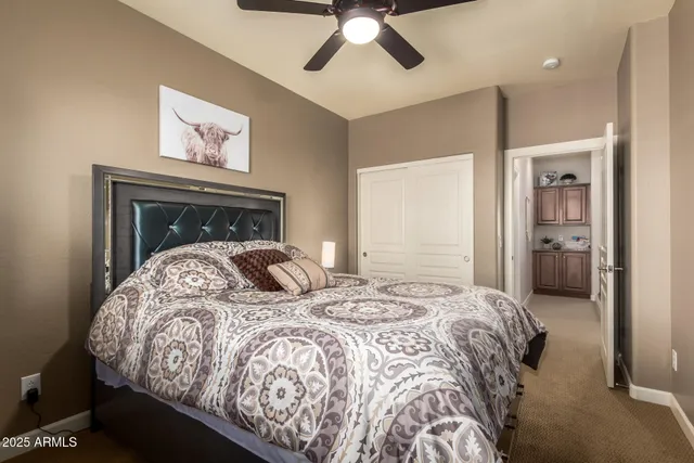 a large bed sitting in a bedroom next to a window