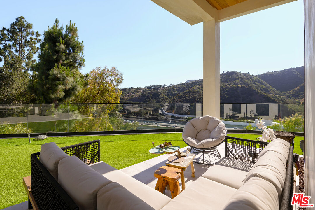 1367 Casiano Road Los Angeles, CA 90049 - Photo 25 of 26 a view of a swimming pool and lounge chairs in back of a lake