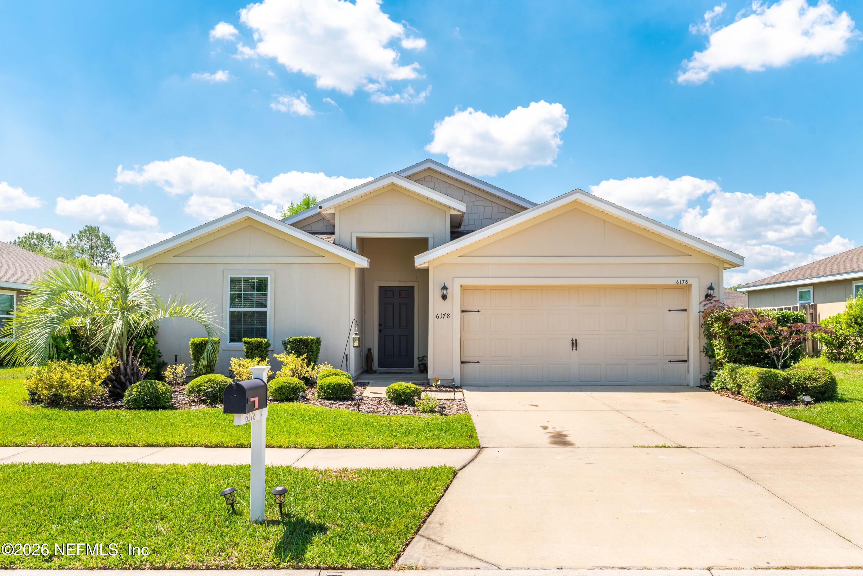 6178 Daylilly Road Macclenny, FL 32063 - Photo 3 of 29 a front view of a house with garden