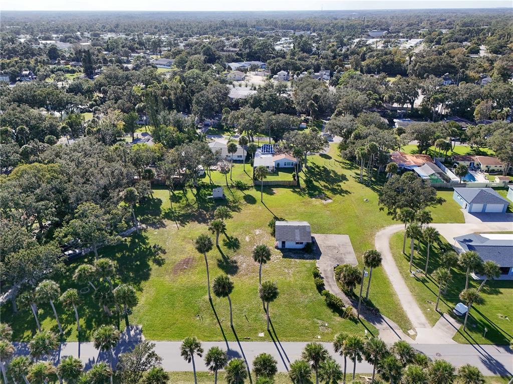 5040 Riverside Drive Port Orange, FL 32127 - Photo 3 of 6 an aerial view of residential houses with outdoor space