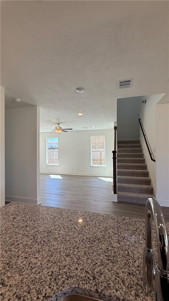 4802 Underbrush Crossing Bryan, TX 77845 - Photo 5 of 8 a view of a hallway with stairs and wooden floor