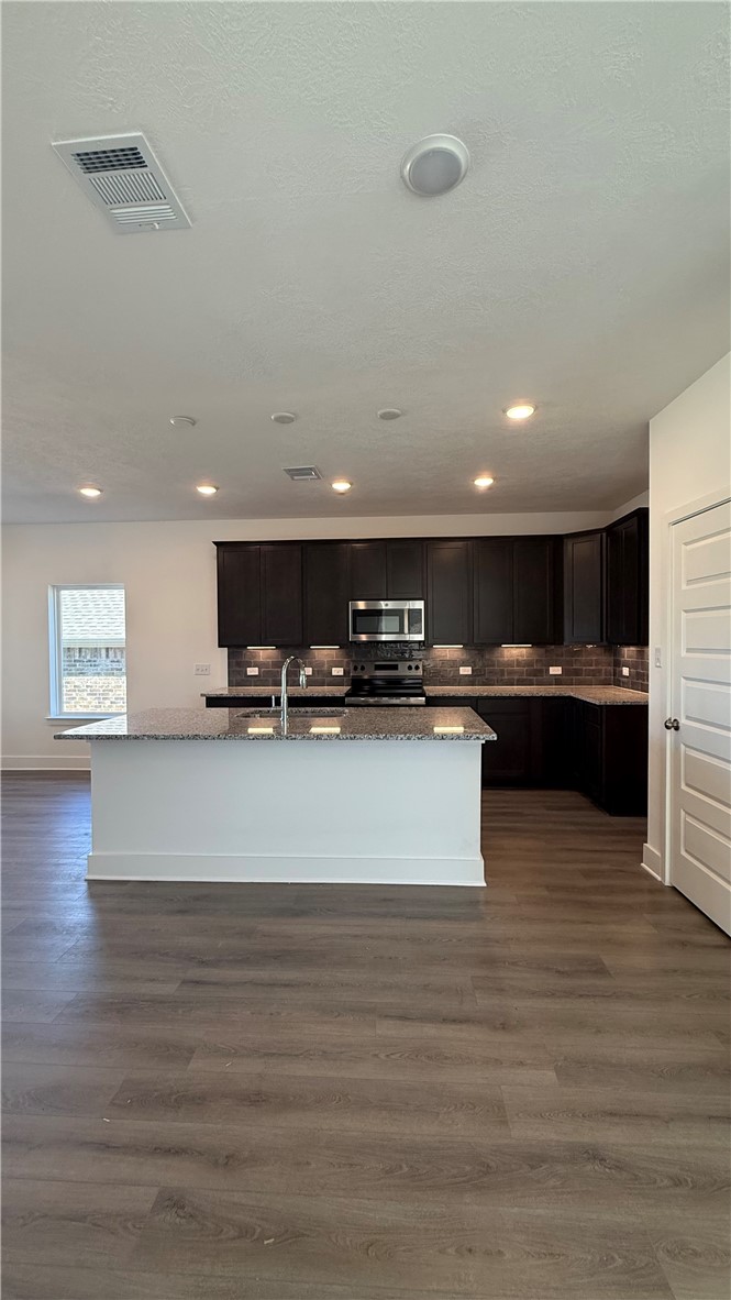 4802 Underbrush Crossing Bryan, TX 77845 - Photo 6 of 8 a view of kitchen with stainless steel appliances kitchen island sink and stove