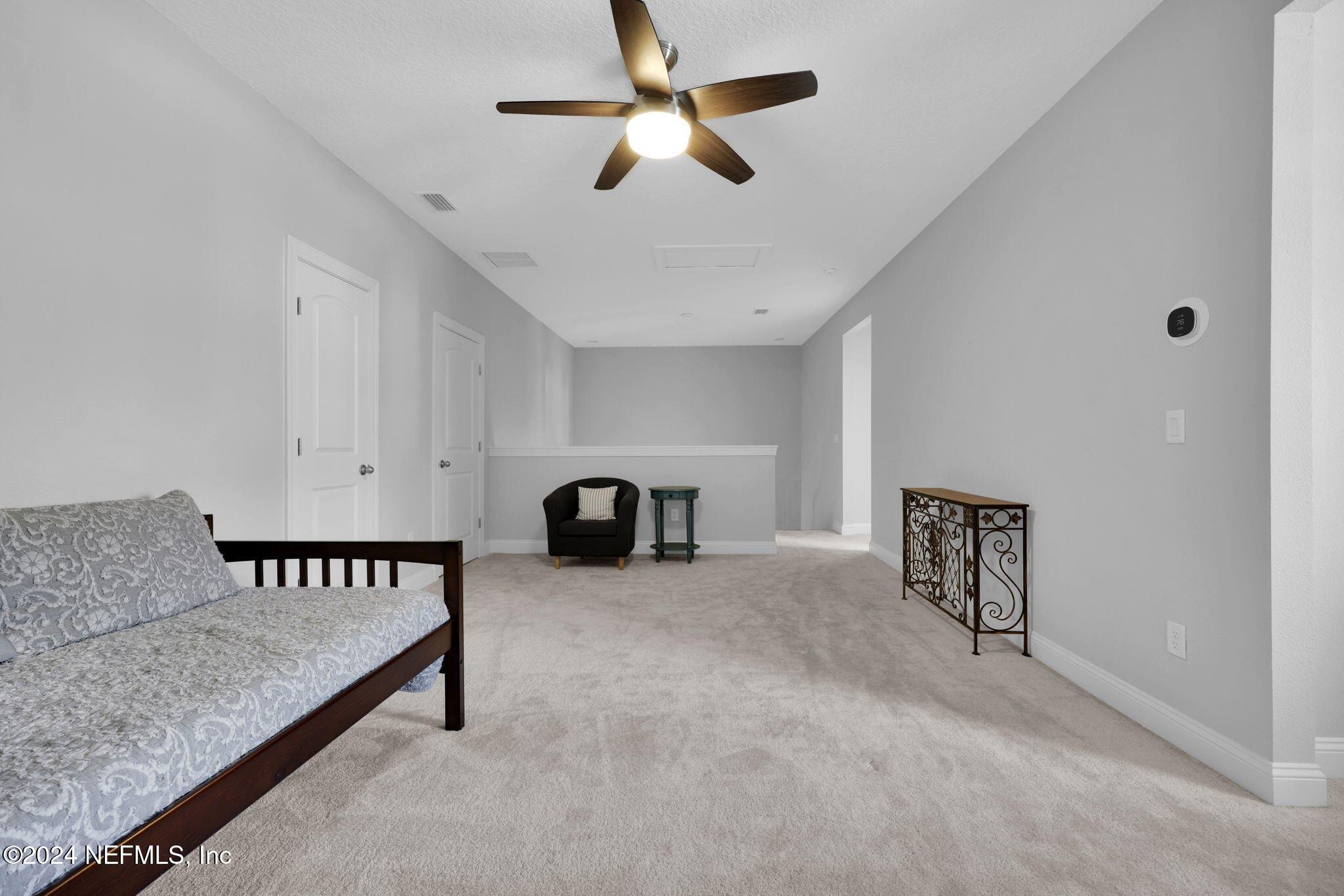 217 Liberty Bell Road Ponte Vedra, FL 32081 - Photo 24 of 50 a spacious bedroom with a bed and a chandelier