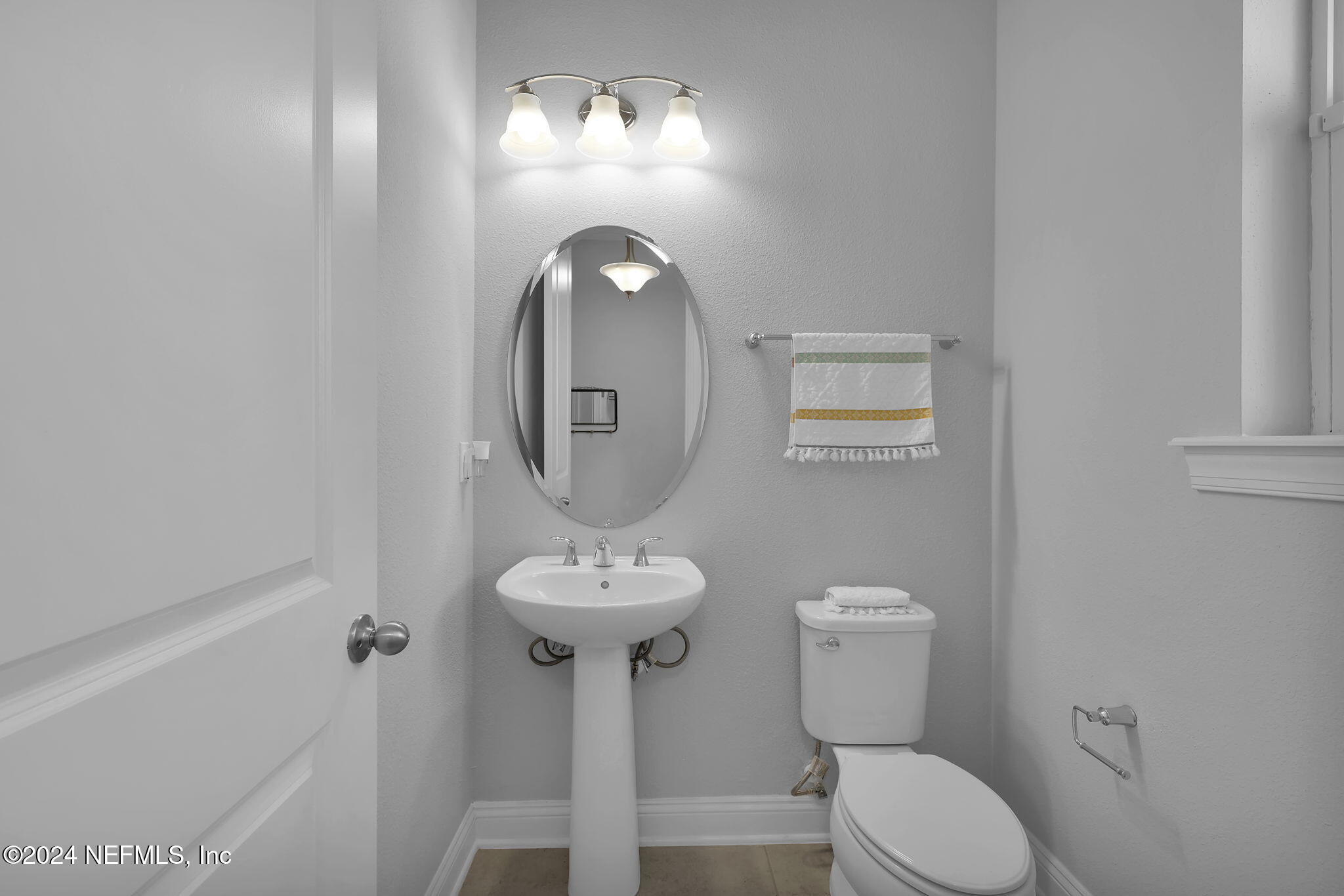 217 Liberty Bell Road Ponte Vedra, FL 32081 - Photo 4 of 50 a bathroom with a toilet sink and mirror