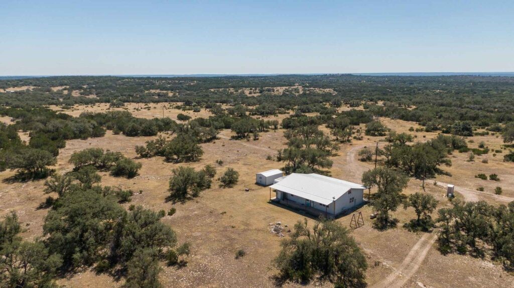 24 County Road 24 Junction, TX 76849 - Photo 2 of 37 an aerial view of a house with a garden