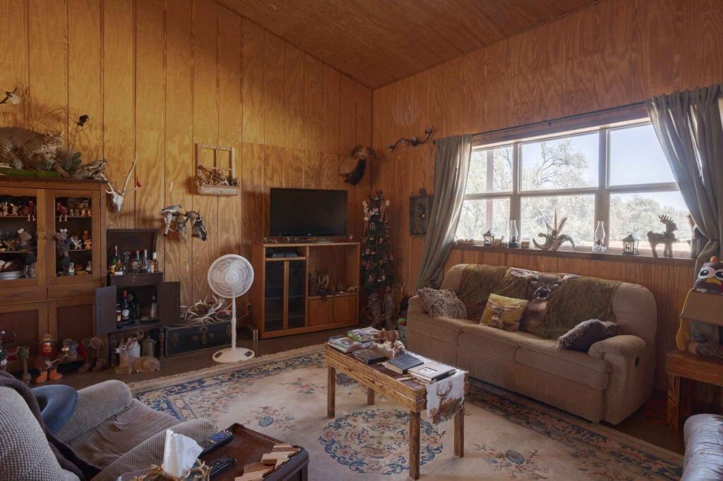 24 County Road 24 Junction, TX 76849 - Photo 22 of 37 a living room with furniture a flat screen tv and a floor to ceiling window