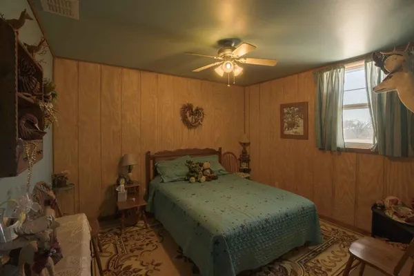 a bed room with a bed and a chair
