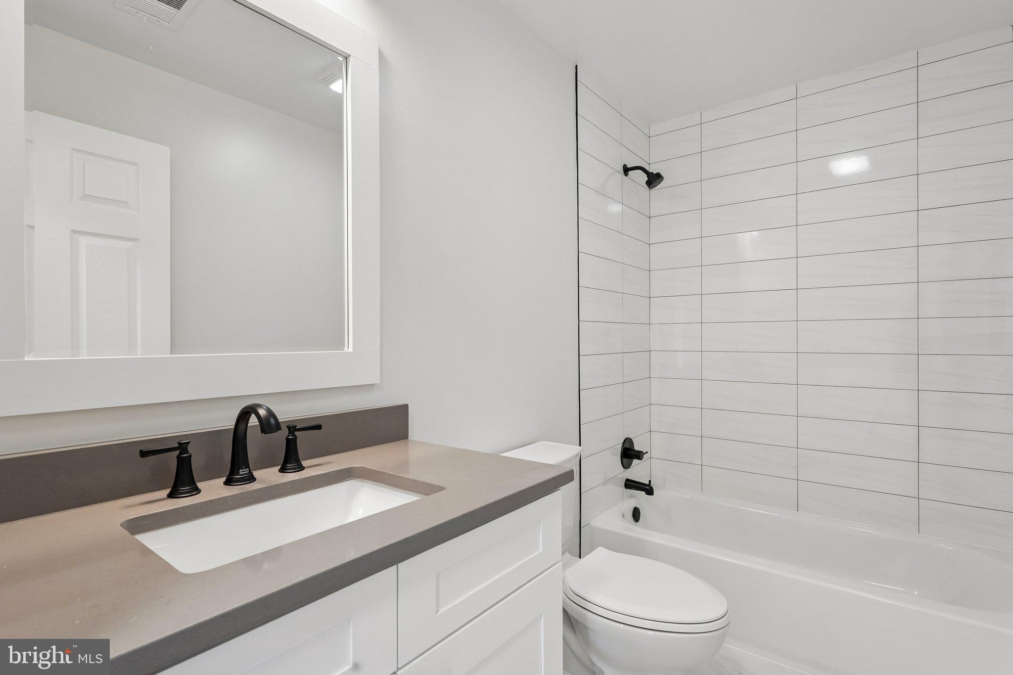 1992 Retta Gilliam Court Southeast Washington, DC 20020 - Photo 10 of 22 a bathroom with a sink a toilet and shower