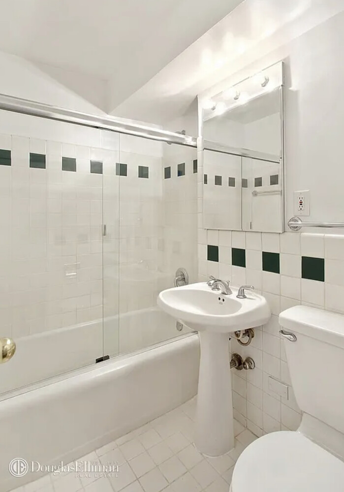 174 East 74th Street, Unit 10E Manhattan, NY 10021 - Photo 5 of 8 a bathroom with a sink toilet and shower