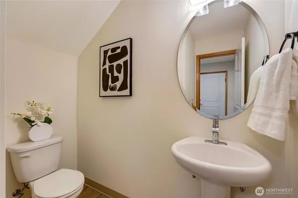 a bathroom with a toilet a sink and mirror