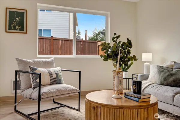 a living room with furniture and a potted plant