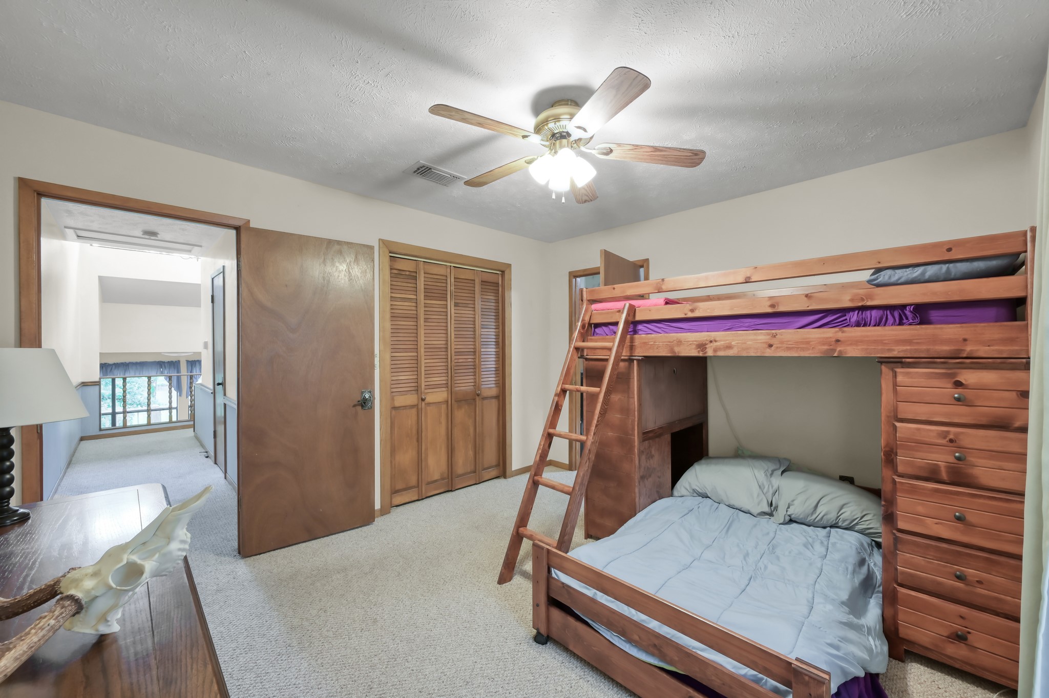 254 Sharp Lane Trinity, TX 75862 - Photo 18 of 36 a bedroom with a bed and a chandelier