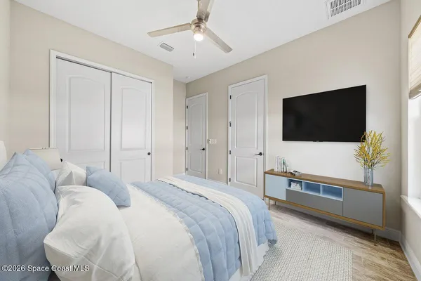 a living room with furniture a flat screen tv and a floor to ceiling window