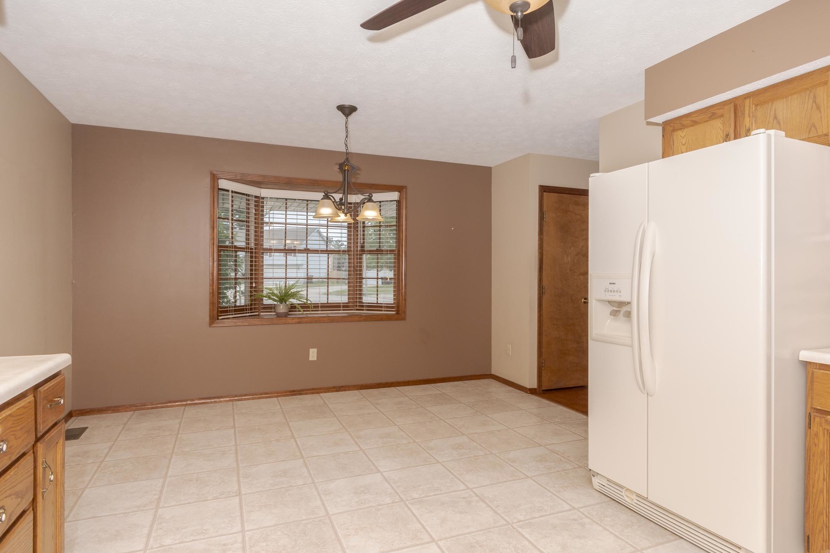 502 Wittenberg Court Normal, IL 61761 - Photo 19 of 41 a view of an empty room with window and cabinet area