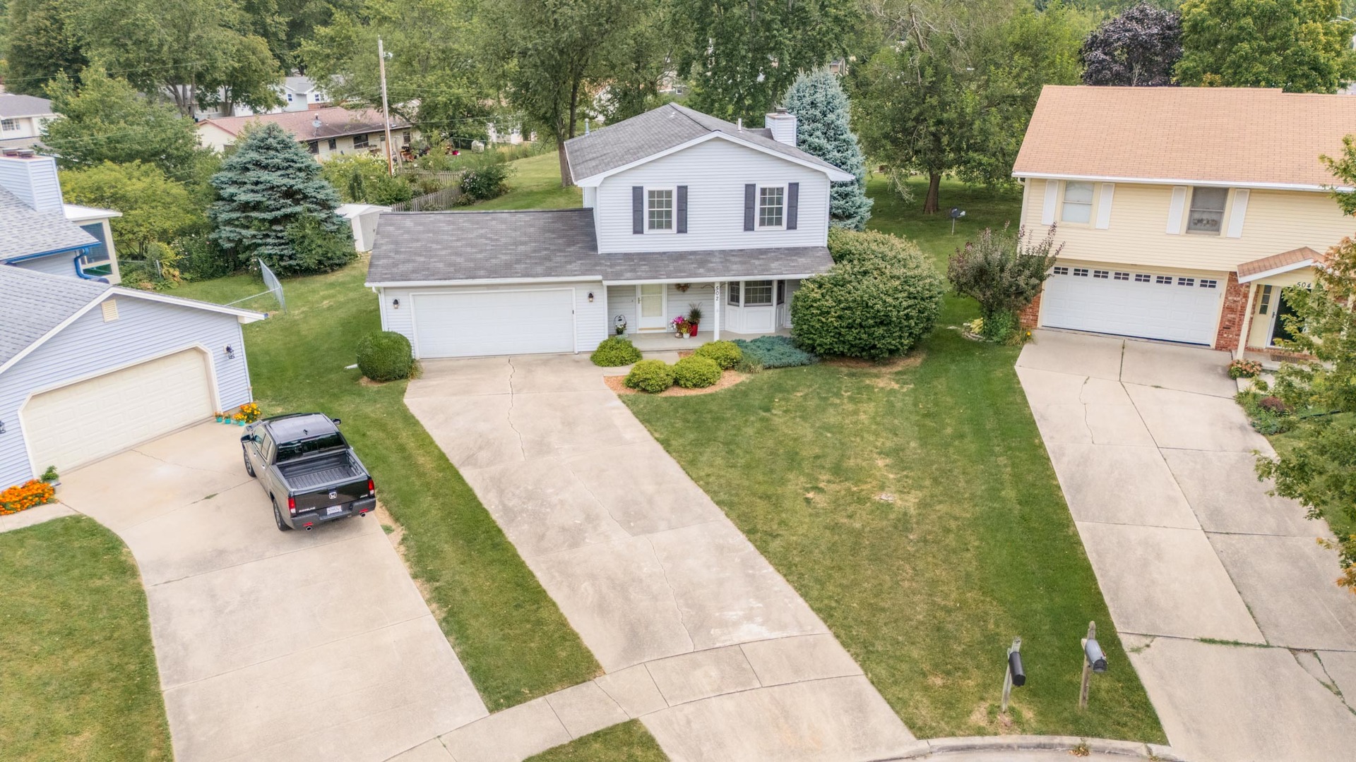 502 Wittenberg Court Normal, IL 61761 - Photo 40 of 41 a view of a white house with a yard plants and a table and chairs