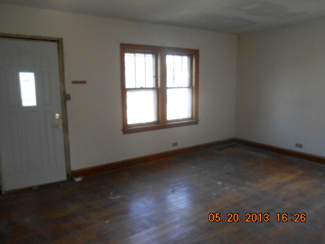 18142 Ridgewood Avenue Lansing, IL 60438 - Photo 3 of 11 an empty room with wooden floor and windows