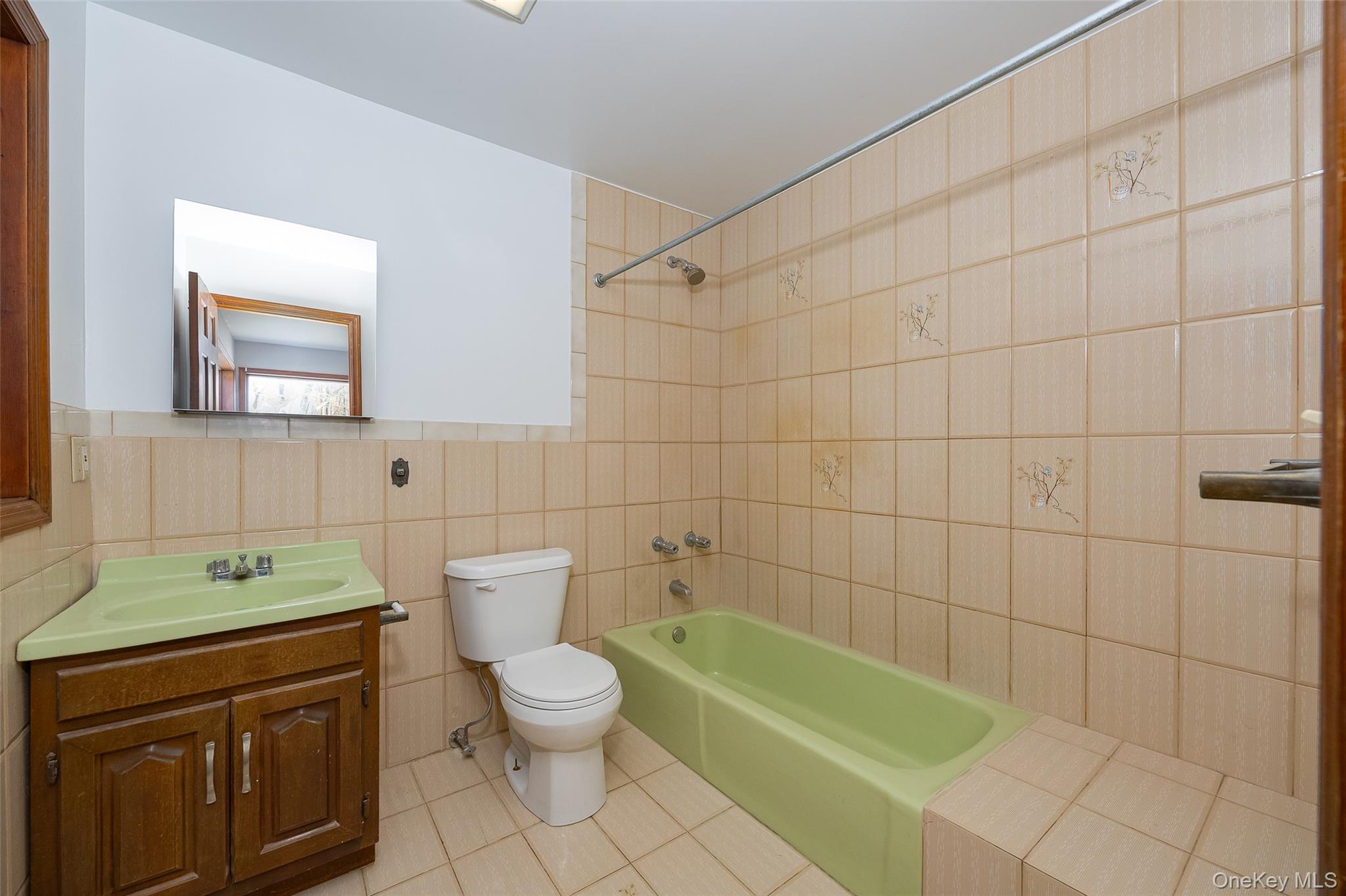 123 Brush Hill Road Millbrook, NY 12545 - Photo 16 of 29 Full first floor bathroom with vanity, bathtub / shower combination, and light tile floors