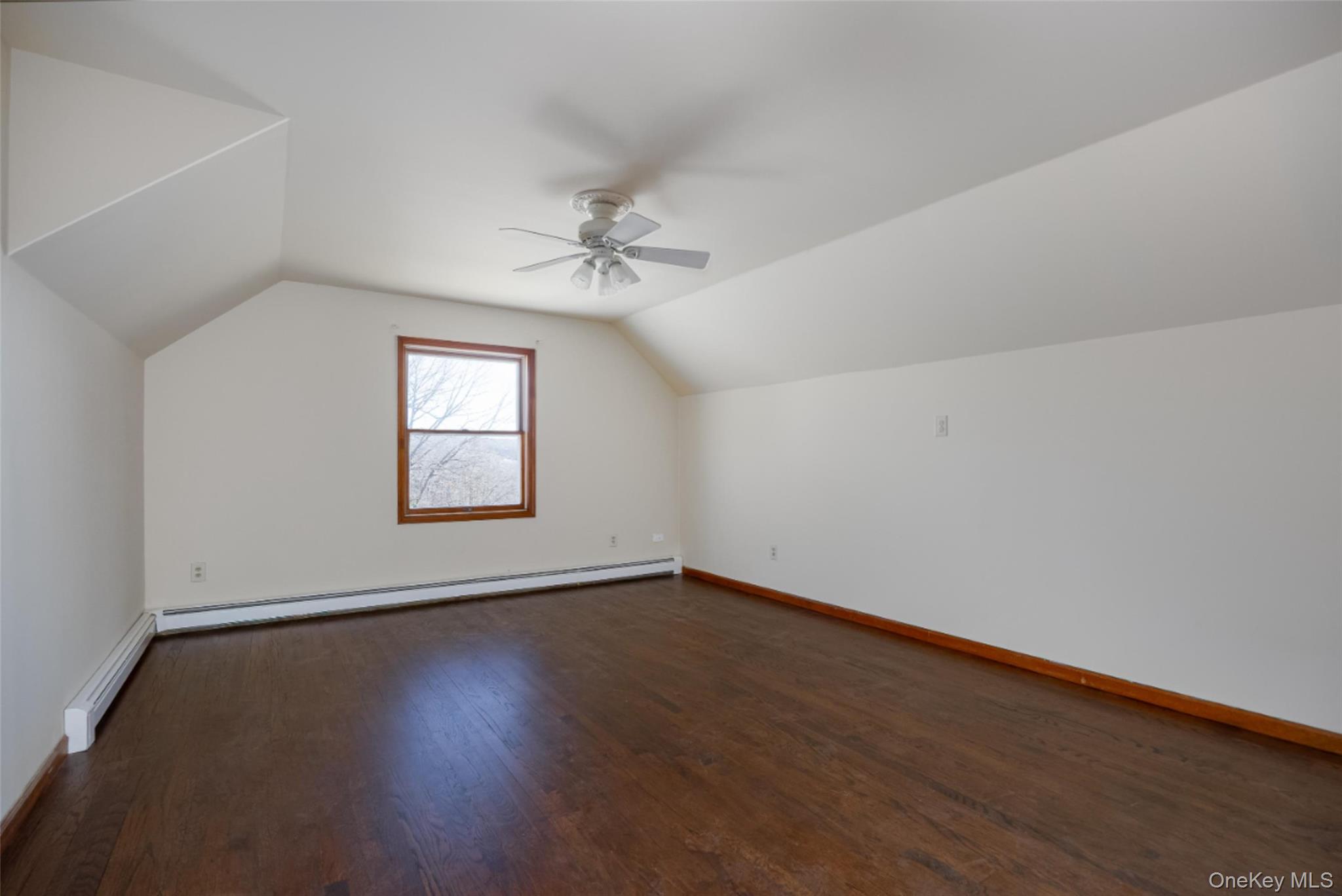 123 Brush Hill Road Millbrook, NY 12545 - Photo 17 of 29 Bedroom 2 featuring vaulted ceiling, walk-in-closet, ceiling fan, and wood floors