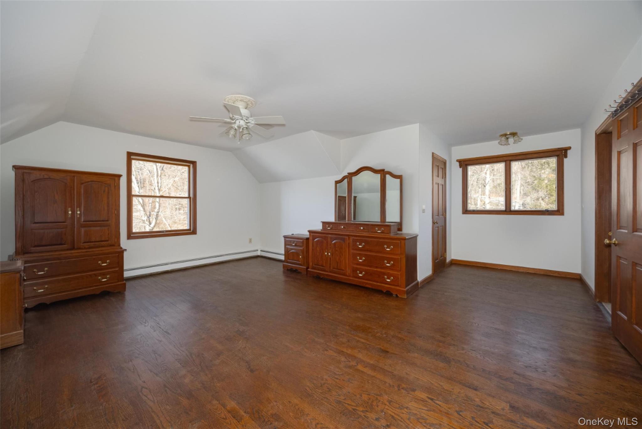 123 Brush Hill Road Millbrook, NY 12545 - Photo 21 of 29 Bedroom 3 with vaulted ceiling, wood floors, a ceiling fan, and walk-in-closet