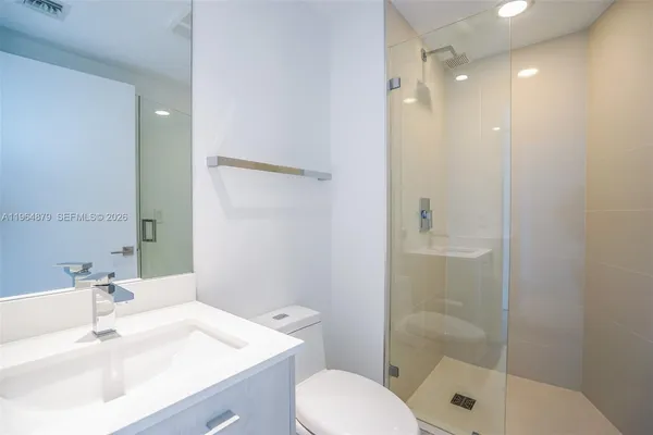 a bathroom with a sink toilet and shower