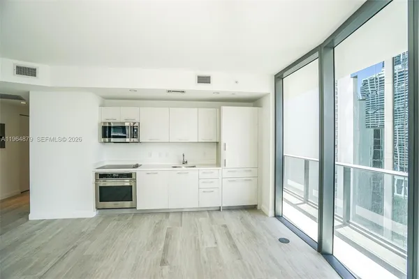 a kitchen with stainless steel appliances a stove top oven and a refrigerator