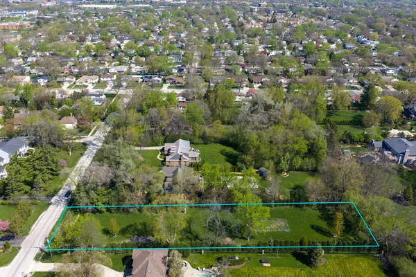 an aerial view of residential houses with outdoor space and swimming pool